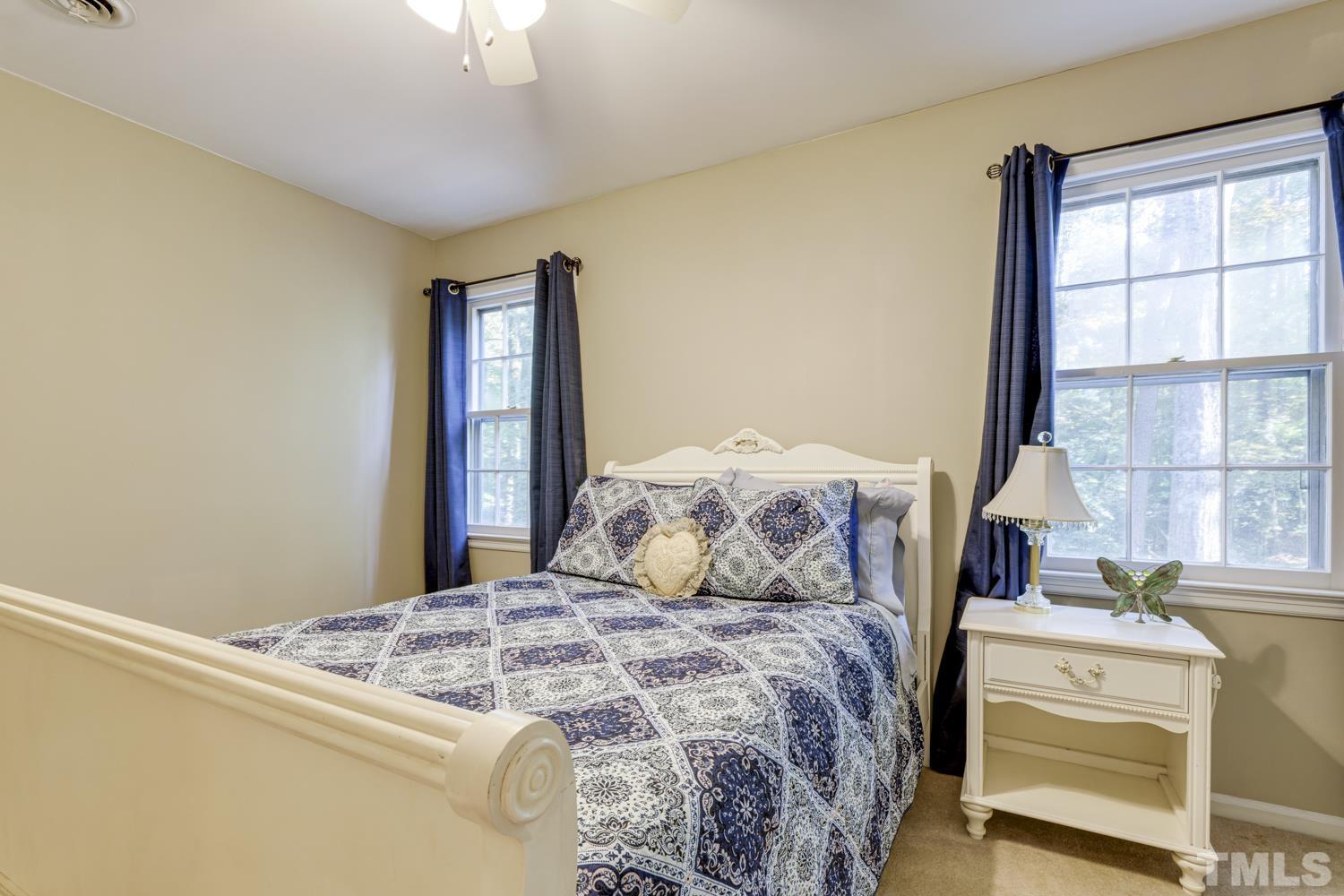 9616 Rock Creek Road Raleigh, NC 27613 - Photo 22 of 28 a bedroom with a bed and a window