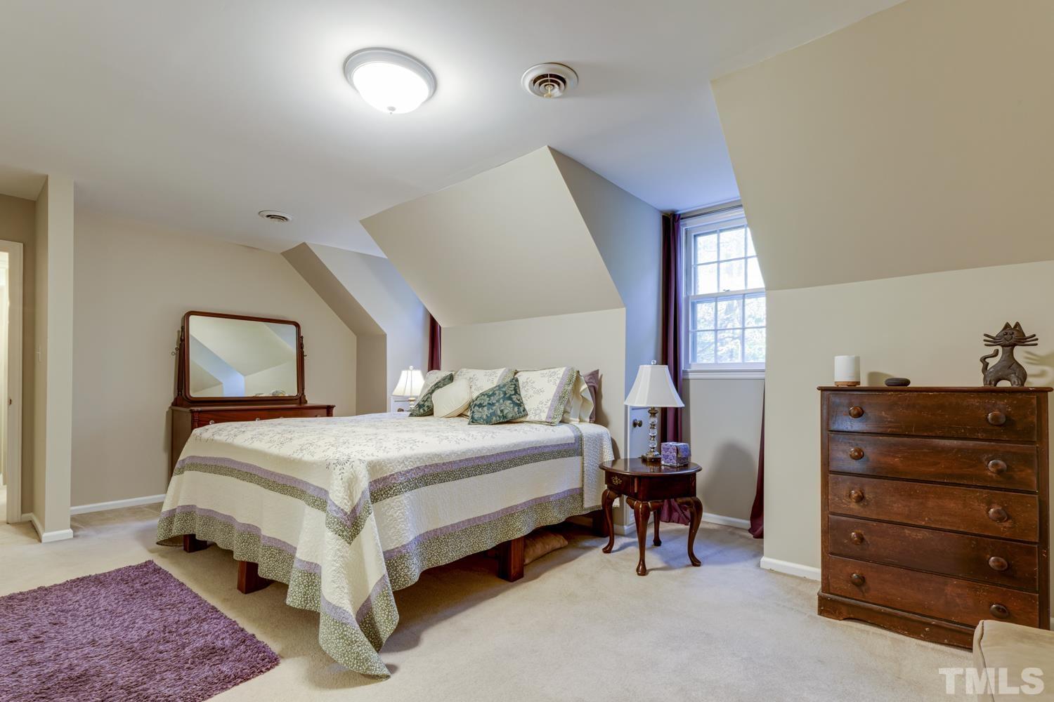 9616 Rock Creek Road Raleigh, NC 27613 - Photo 25 of 28 a bedroom with a bed and window