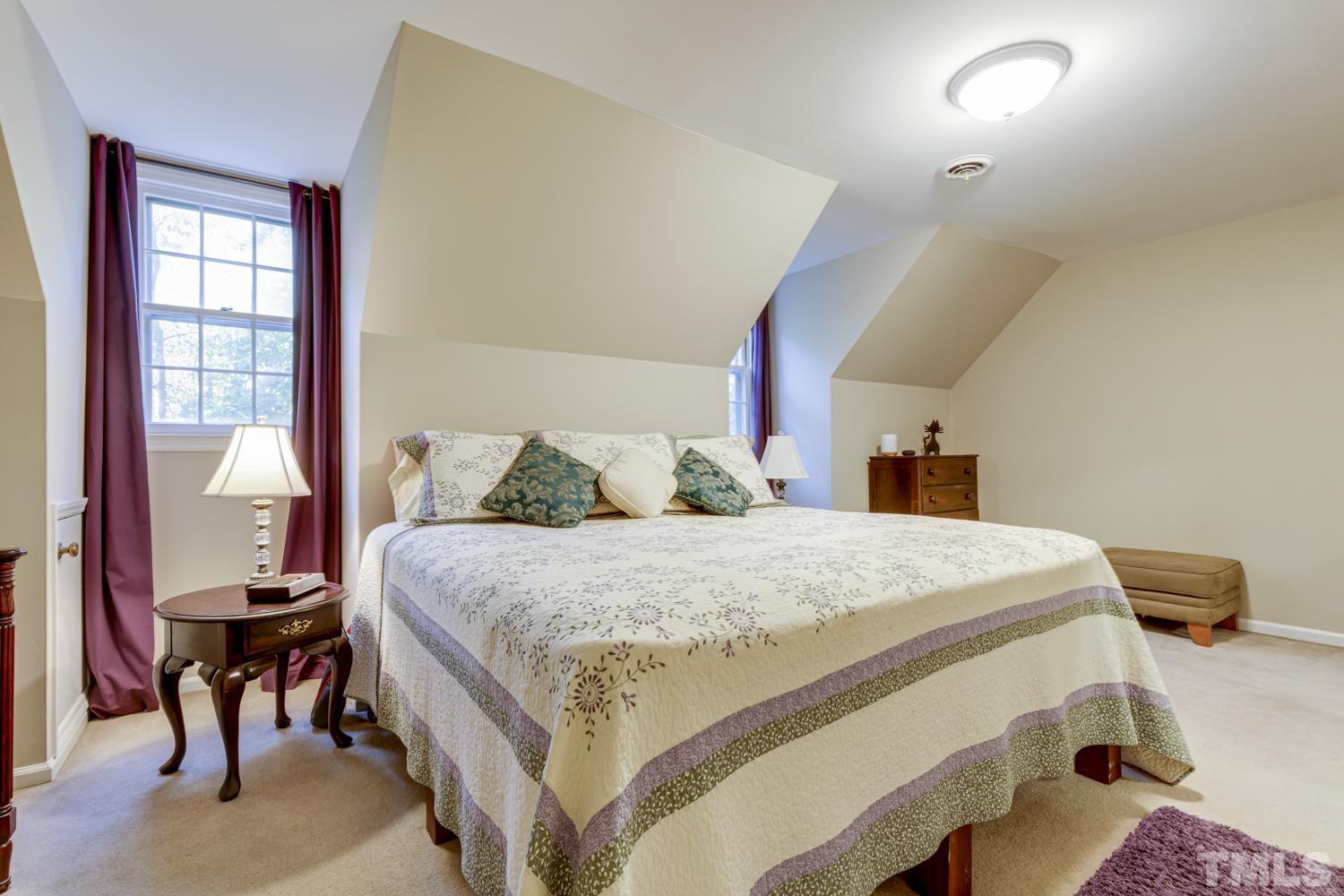 9616 Rock Creek Road Raleigh, NC 27613 - Photo 28 of 28 a bed sitting in a bedroom next to a window
