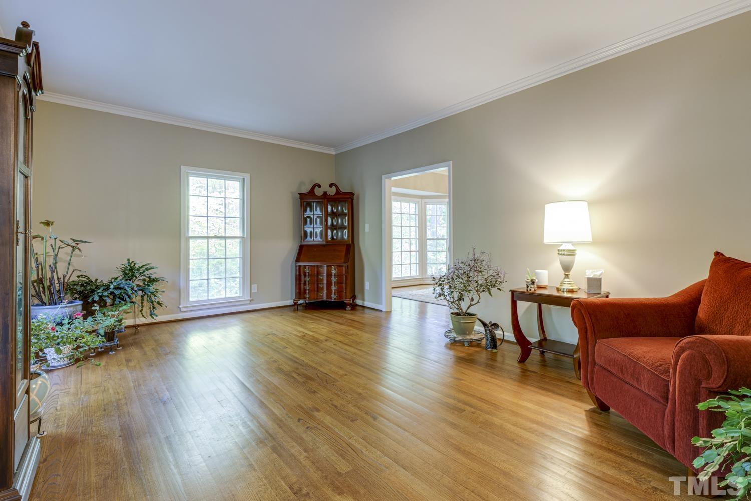 9616 Rock Creek Road Raleigh, NC 27613 - Photo 8 of 28 a living room with furniture and a wooden floor