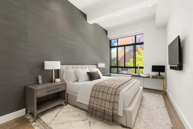 a kitchen with a sink a stove and chairs with wooden floor