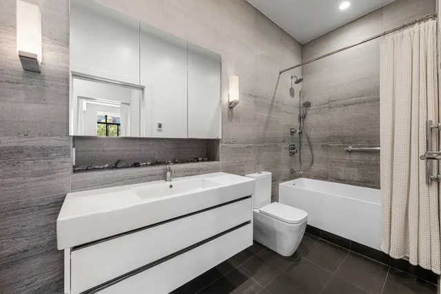 a kitchen with stainless steel appliances kitchen island granite countertop a table chairs and a refrigerator