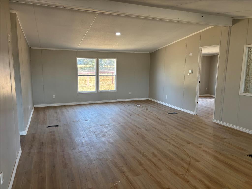 7431 Grubbs Road Aubrey, TX 76227 - Photo 5 of 17 Open-concept living area featuring wood-finish flooring, recessed lighting, and neutral wall tones