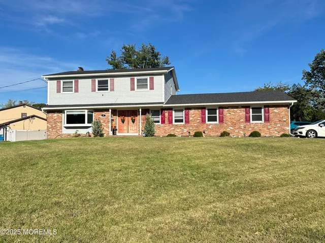 a front view of a house with a yard table and chairs