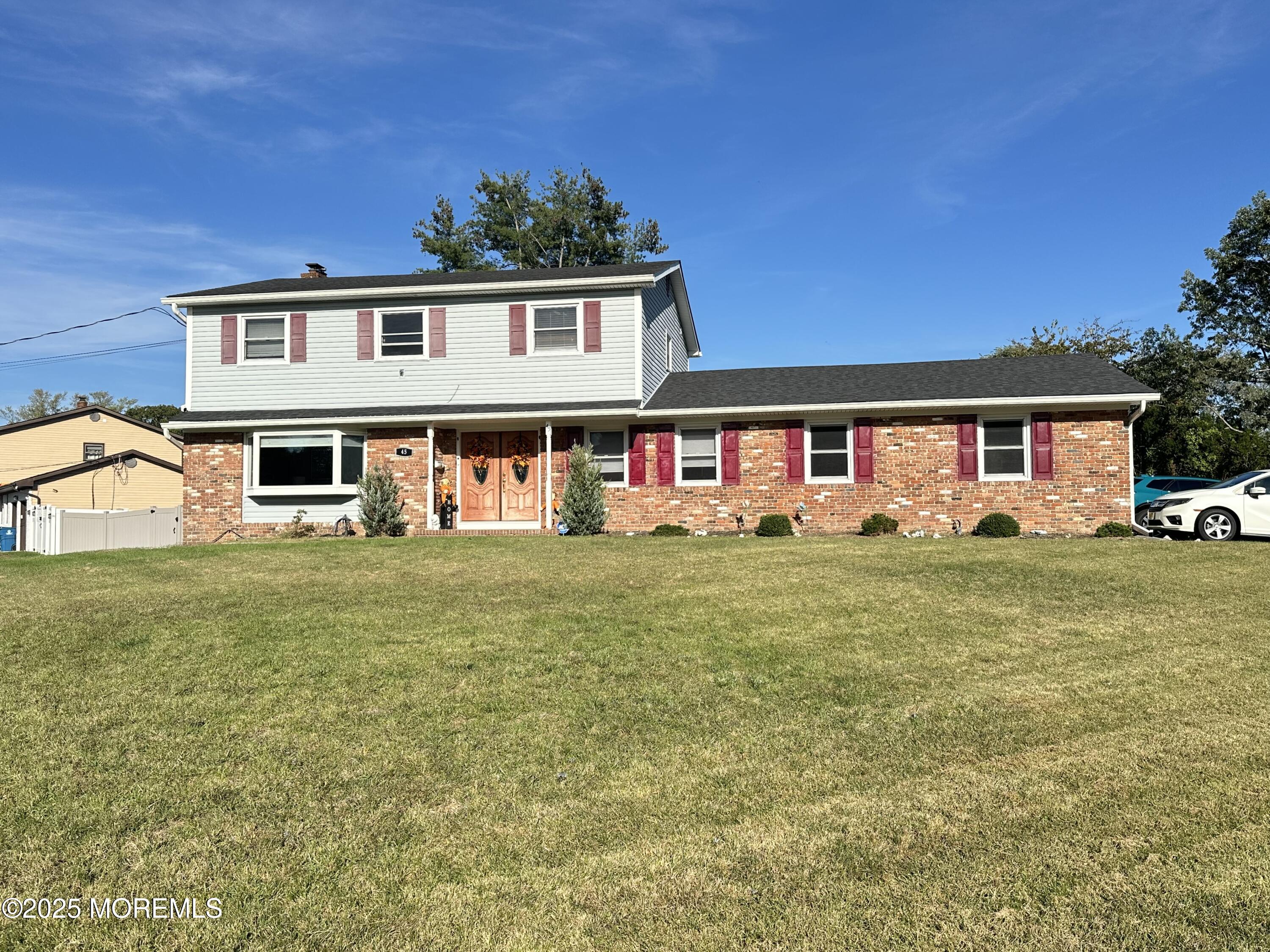 a front view of a house with a yard table and chairs
