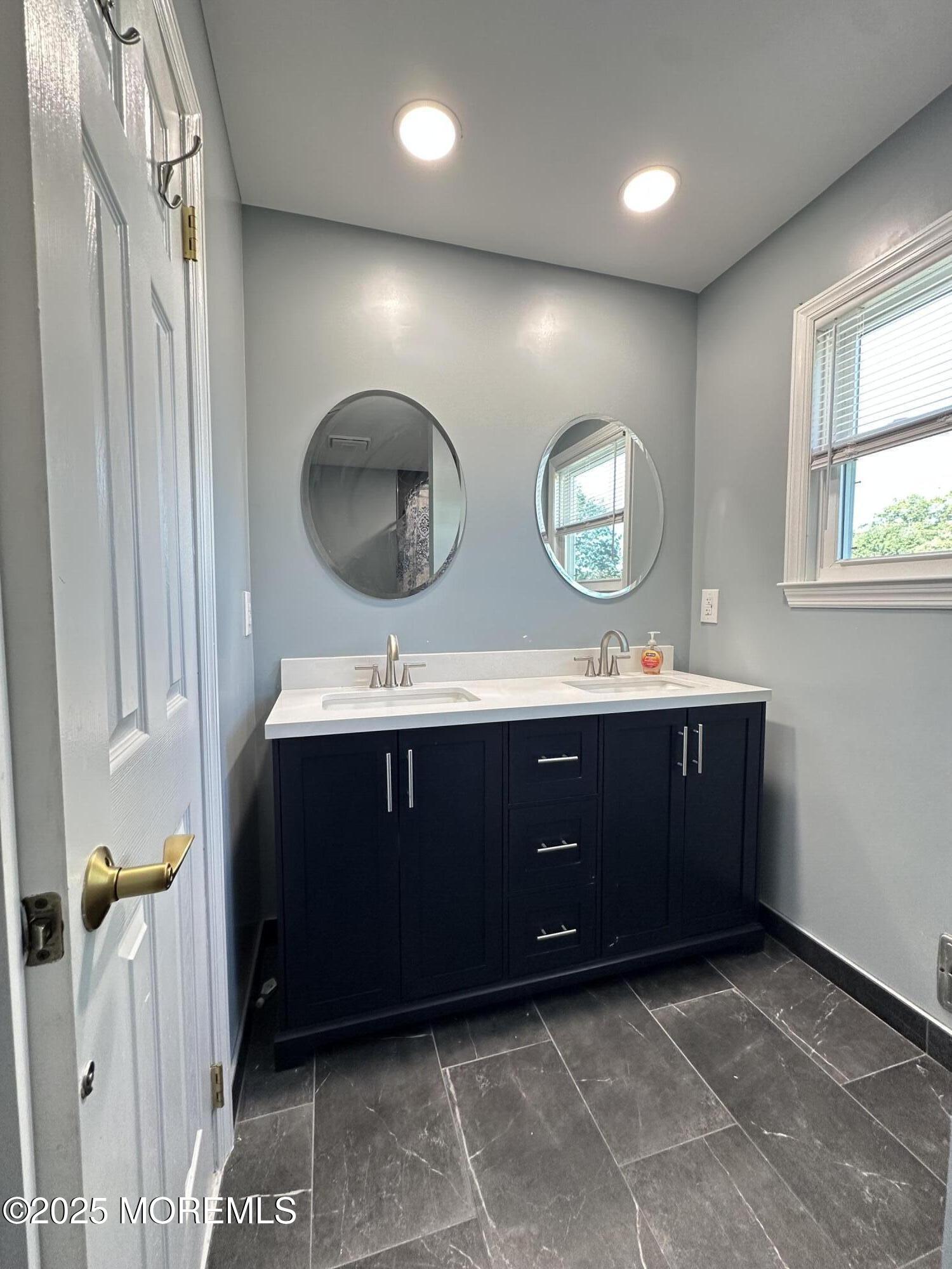 45 Springhill Drive Howell, NJ 07731 - Photo 17 of 22 a bathroom with a double vanity sink and a mirror