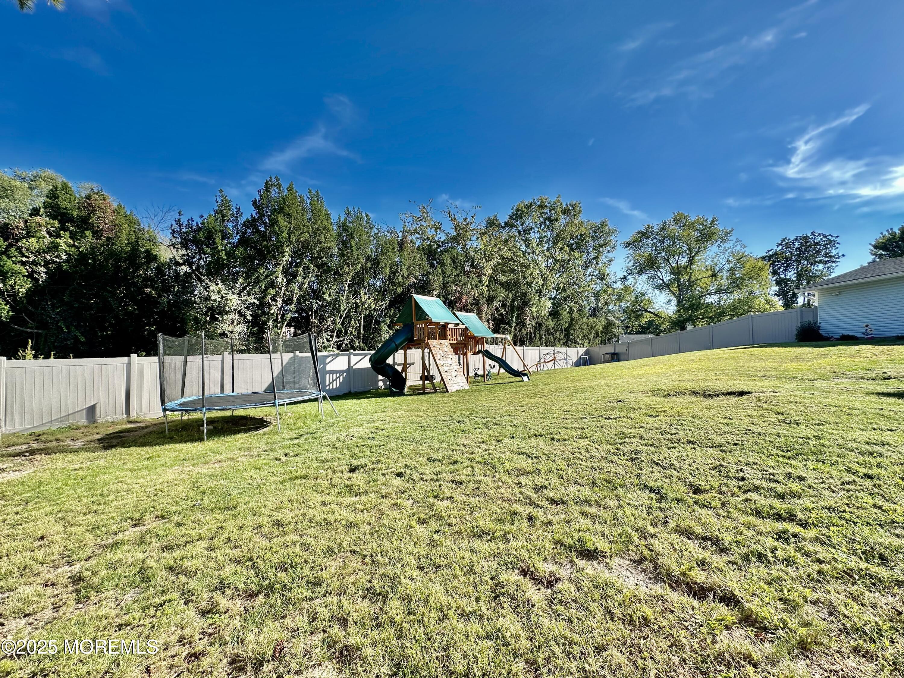 45 Springhill Drive Howell, NJ 07731 - Photo 20 of 22 a backyard of a house with lots of green space