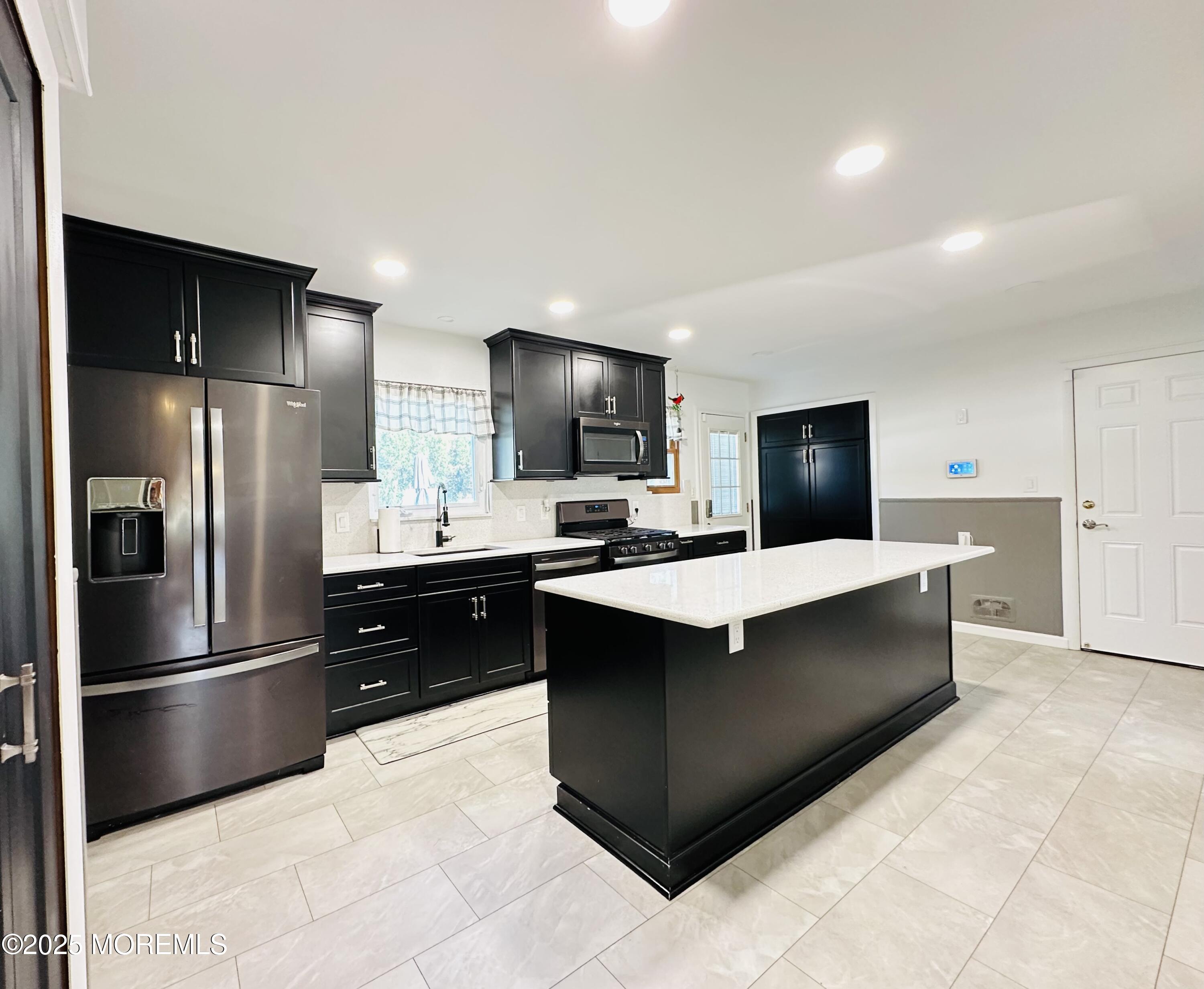45 Springhill Drive Howell, NJ 07731 - Photo 7 of 22 a large kitchen with stainless steel appliances a refrigerator and a sink