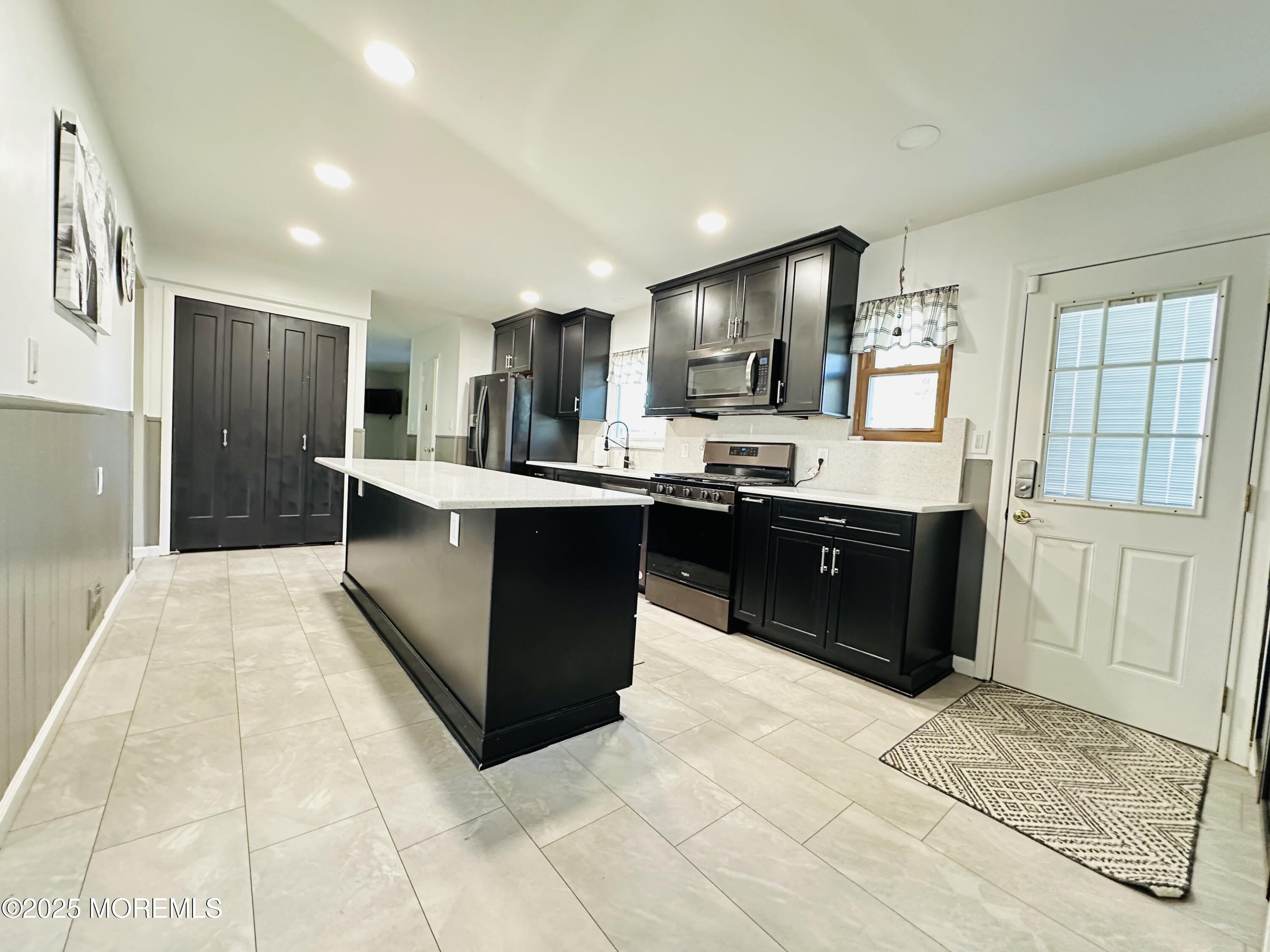 45 Springhill Drive Howell, NJ 07731 - Photo 8 of 22 a kitchen with stainless steel appliances granite countertop a sink counter and cabinets