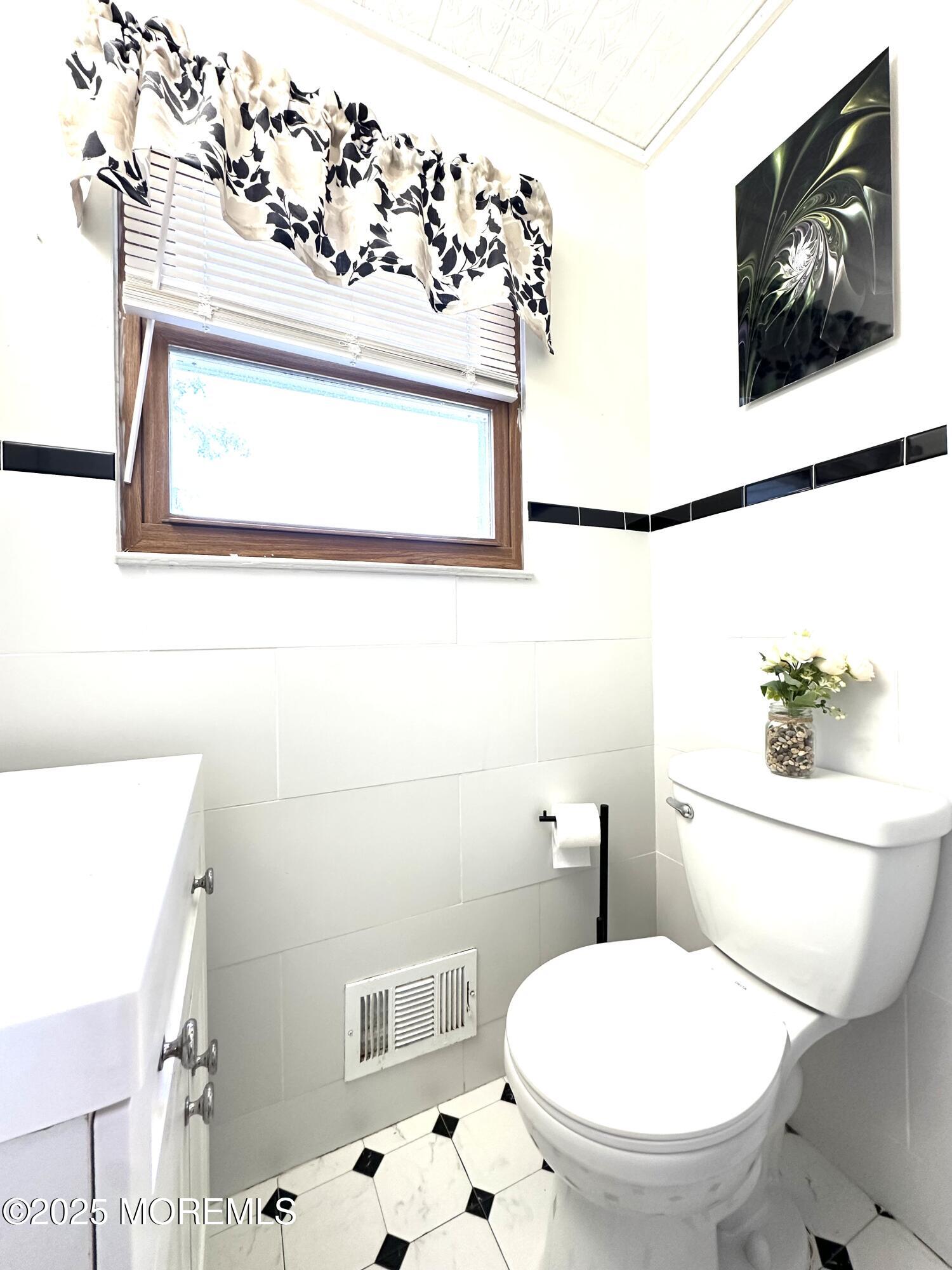 45 Springhill Drive Howell, NJ 07731 - Photo 9 of 22 a white toilet sitting next to a bathroom sink