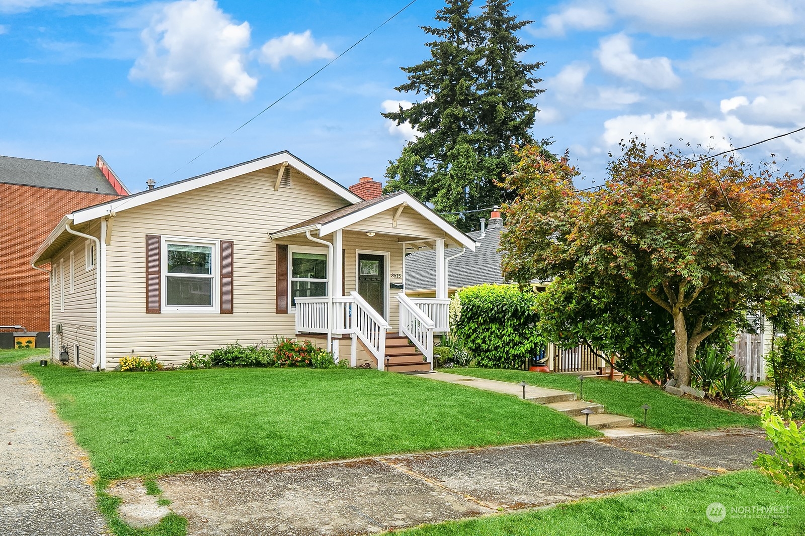 3515 Southwest Austin Street Seattle, WA 98126 - Photo 3 of 35 a front view of a house with a garden and yard