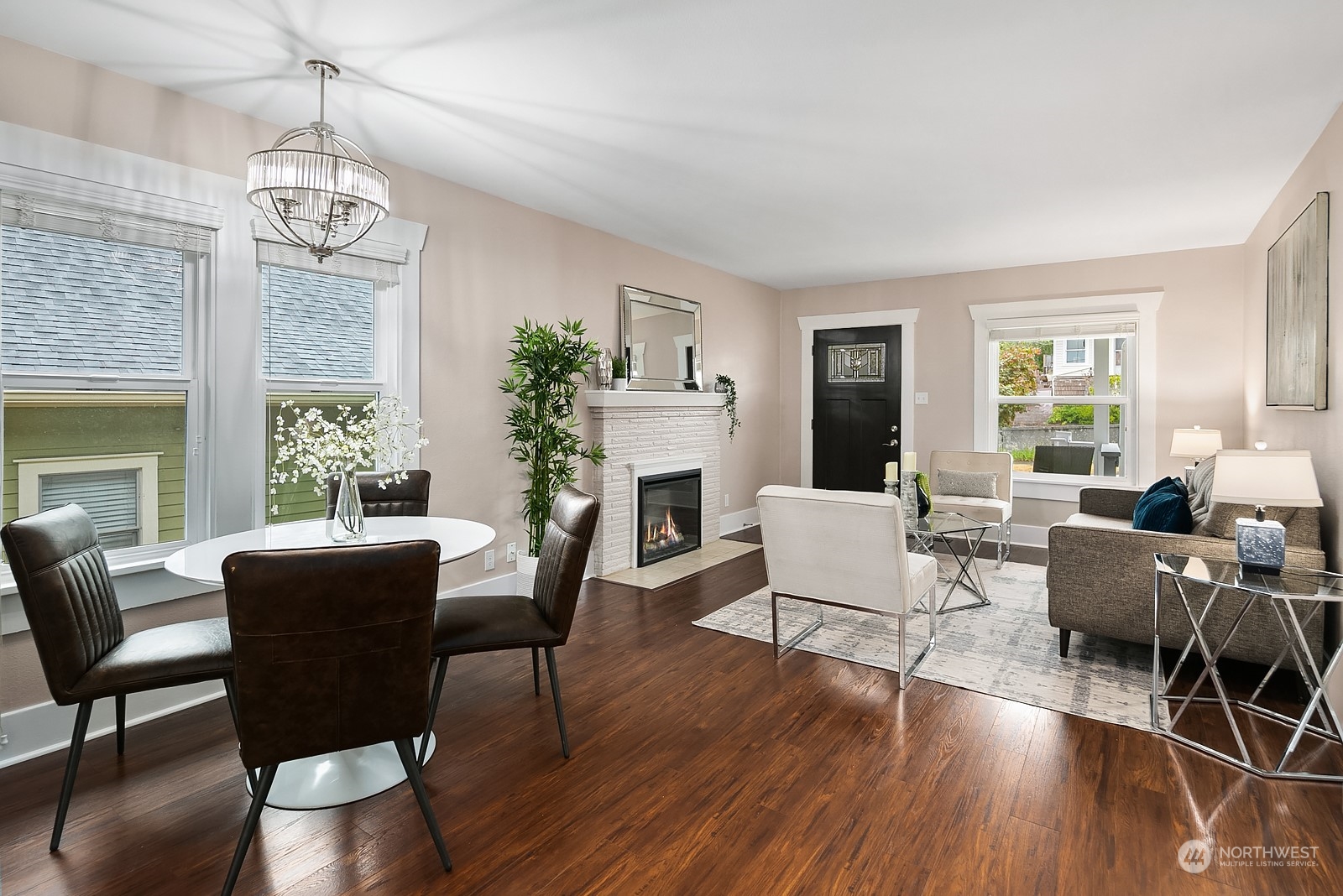 3515 Southwest Austin Street Seattle, WA 98126 - Photo 9 of 35 a dining room with wooden floor a chandelier a glass table and chairs