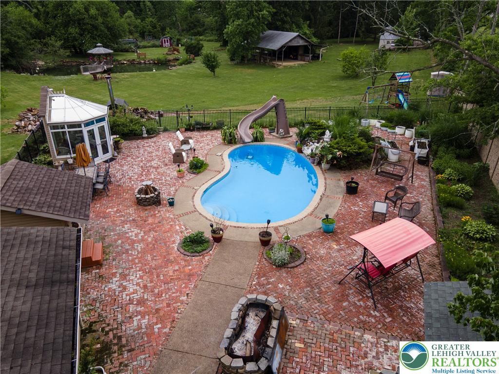 2485 Hieter Road Quakertown, PA 18951 - Photo 75 of 97 A private backyard oasis features a shimmering pool, extensive brick paving, and verdant landscaping.