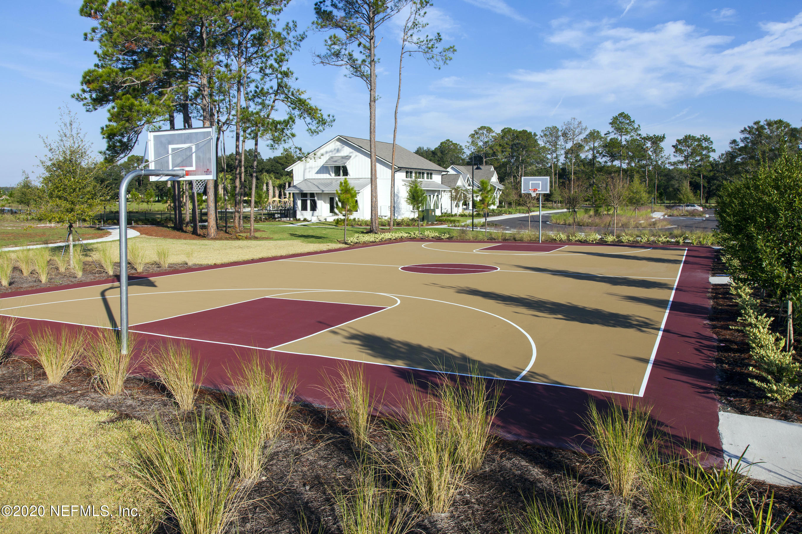 1055 Rustic Mill Dr Street St. Augustine, FL 32092 - Photo 25 of 39 a view of a tennis ground with large trees