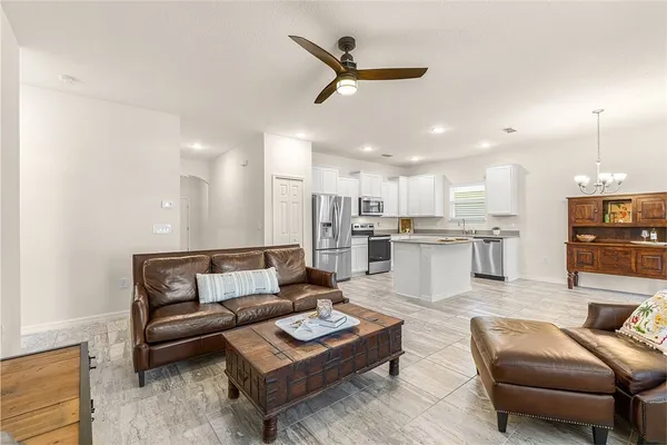a living room with furniture kitchen view and a kitchen view