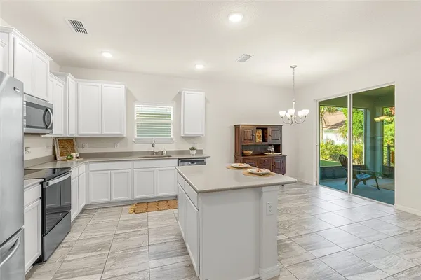 a kitchen with stainless steel appliances granite countertop a sink and a stove