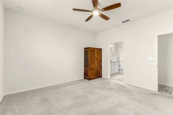 a view of a livingroom with a projector and a ceiling fan