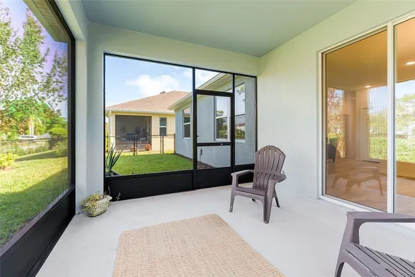 a bedroom with a bed and large windows