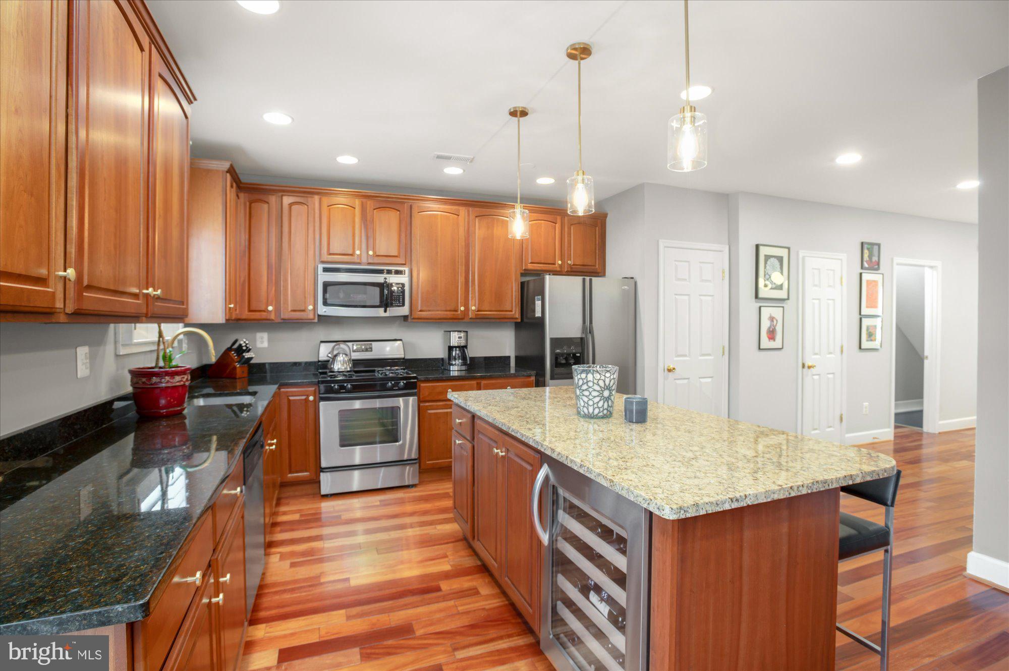 323 T Street Northwest Washington, DC 20001 - Photo 11 of 35 a kitchen with granite countertop kitchen island stainless steel appliances a stove sink microwave and cabinets