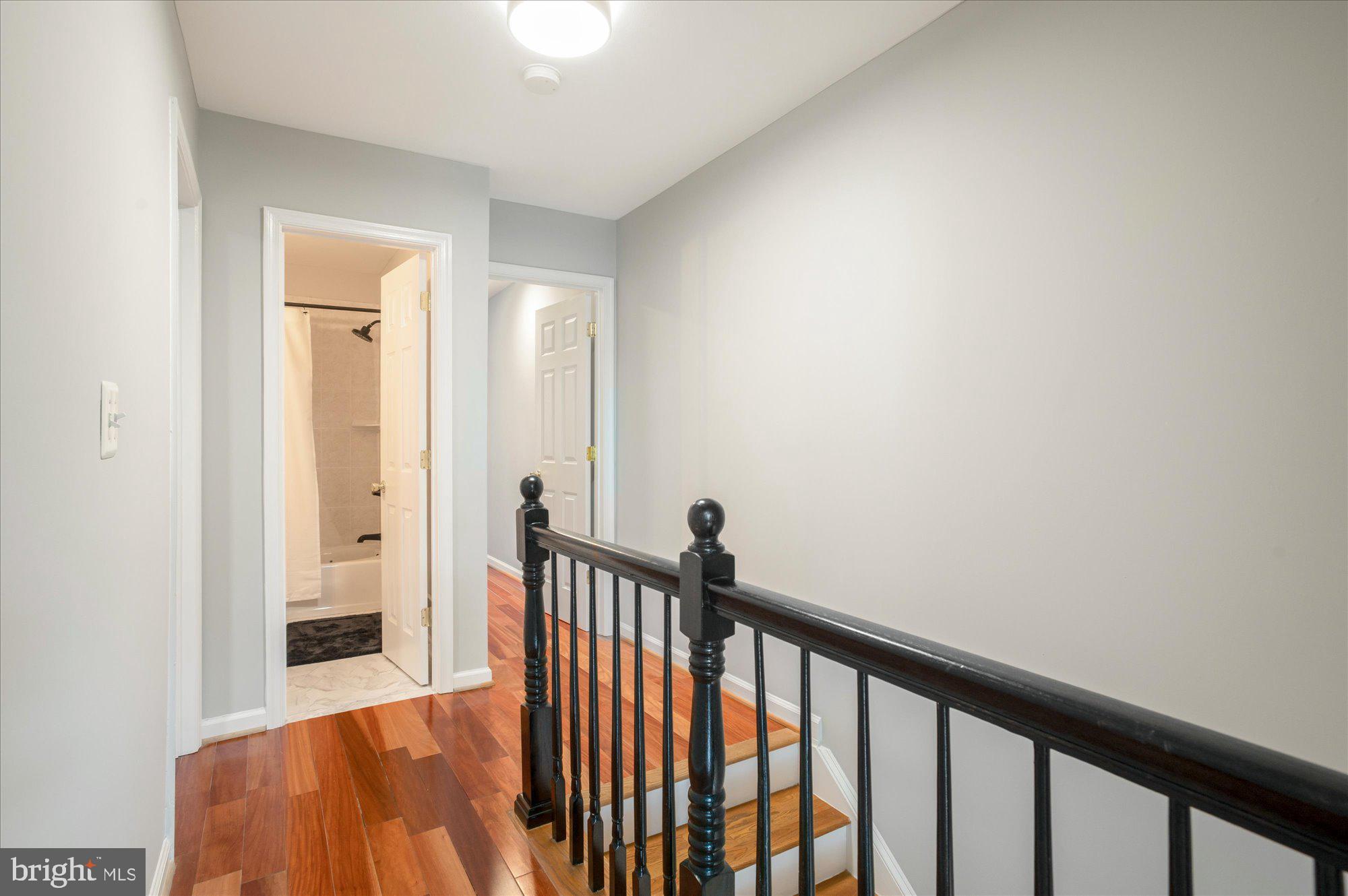 323 T Street Northwest Washington, DC 20001 - Photo 14 of 35 a view of a hallway with wooden floor and a bathroom