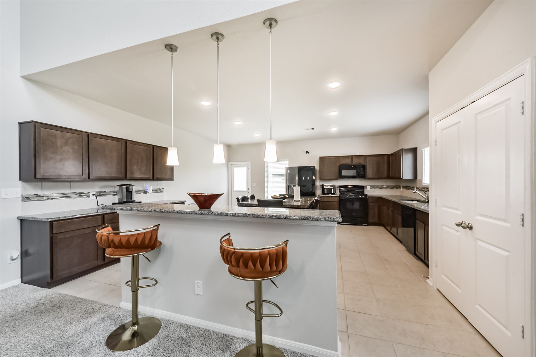 3607 Crosspointe Pass Angleton, TX 77515 - Photo 11 of 46 a kitchen with living room furniture and flat screen tv