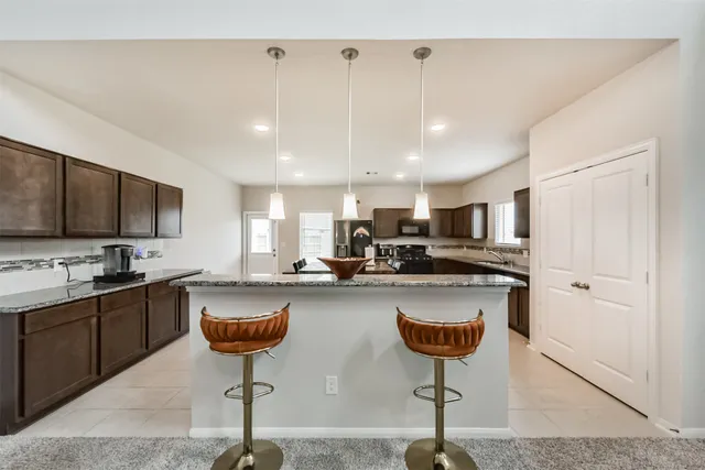 a kitchen with lots of counter space dining table and chairs