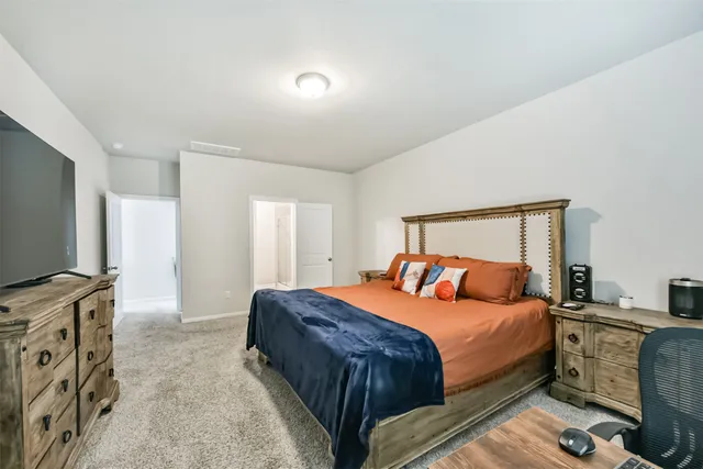 a bedroom with a bed and a flat screen tv