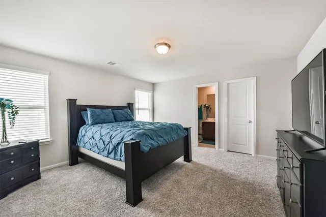 a bedroom with a bed and a view of bathroom