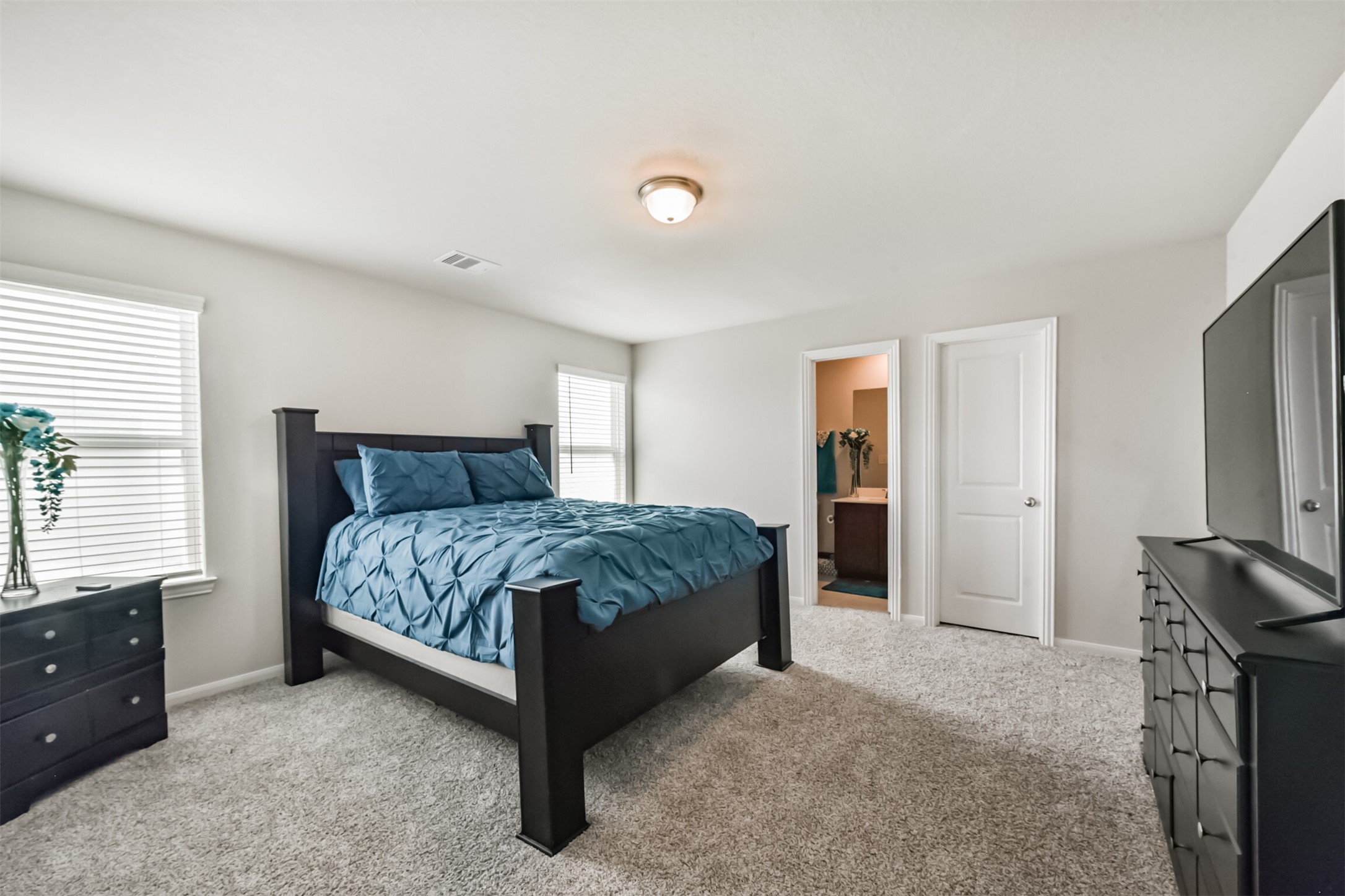 3607 Crosspointe Pass Angleton, TX 77515 - Photo 28 of 46 a bedroom with a large bed and a dresser