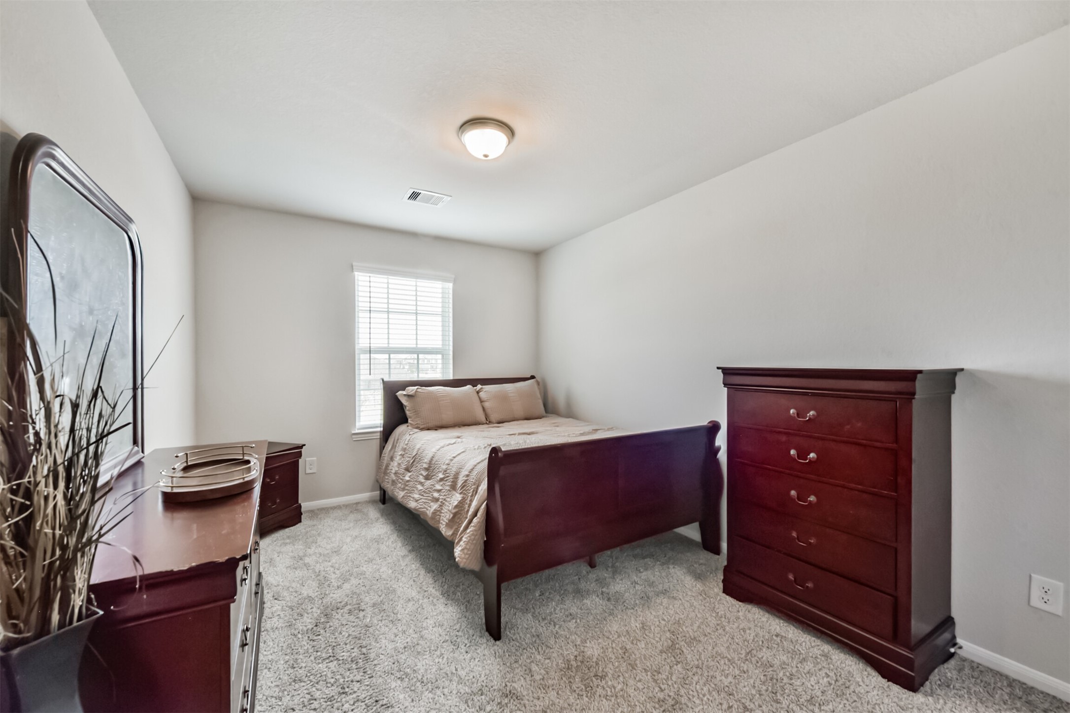 3607 Crosspointe Pass Angleton, TX 77515 - Photo 31 of 46 a spacious bedroom with a bed and a dresser in it