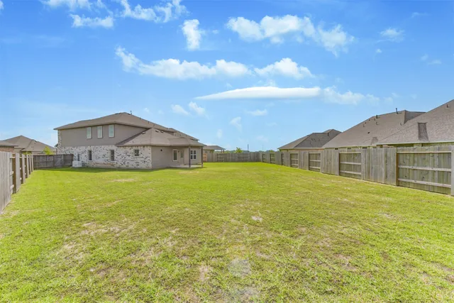 a view of a house with pool and a yard