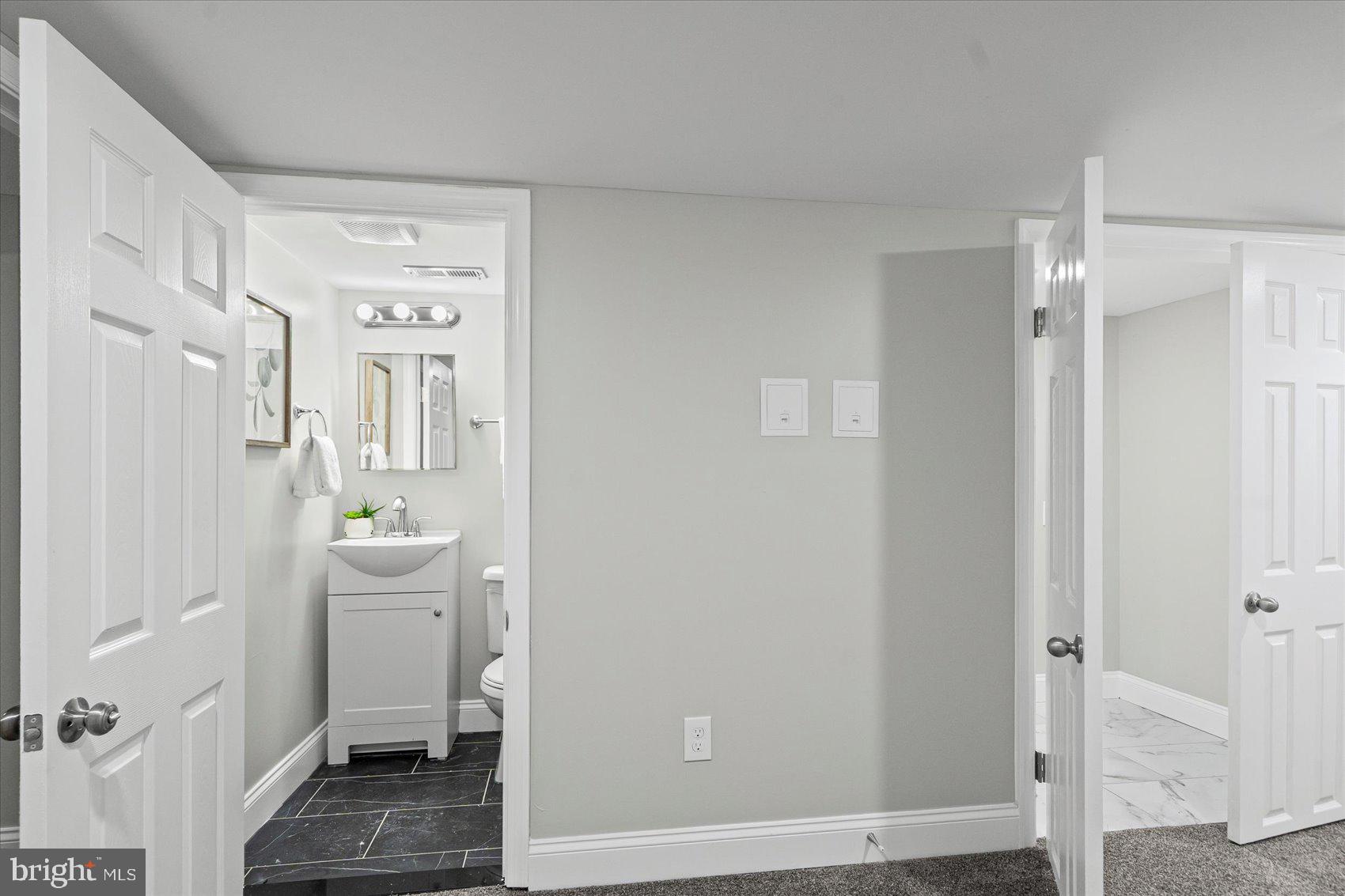 3814 Flowerton Road Baltimore, MD 21229 - Photo 18 of 42 a bathroom with a sink a toilet and shower
