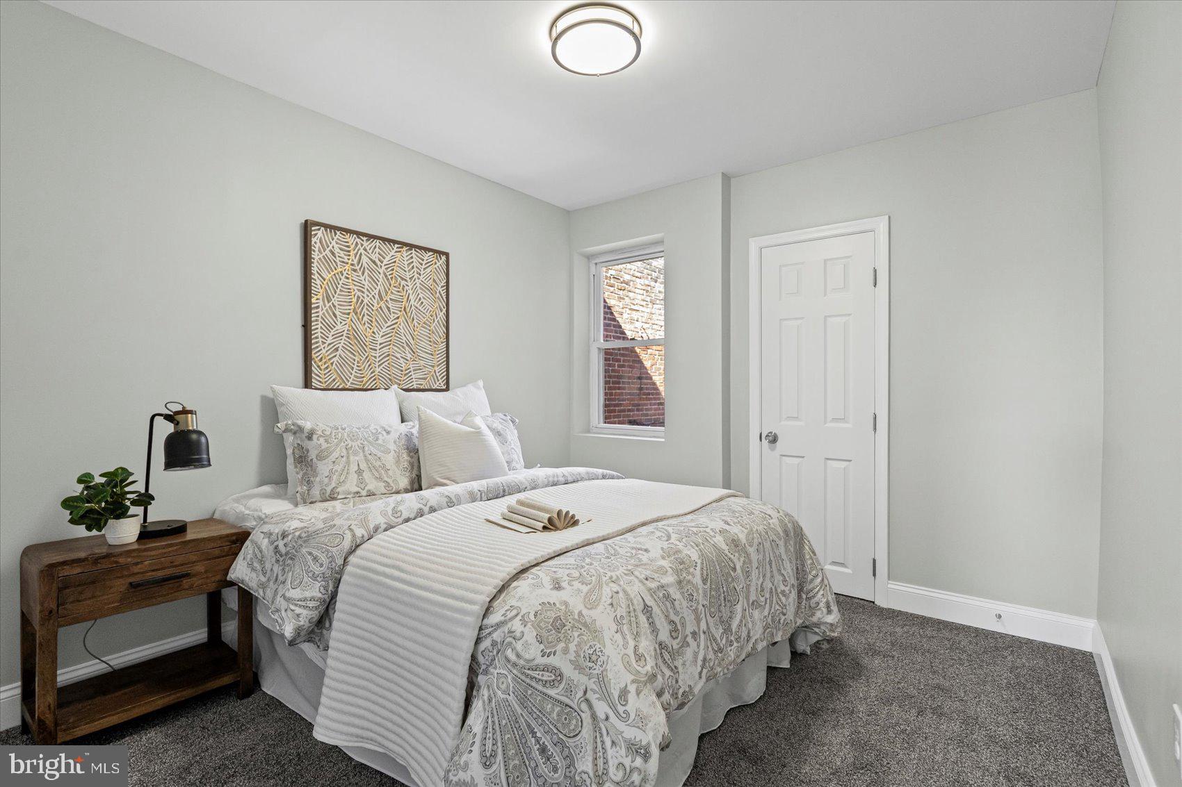 3814 Flowerton Road Baltimore, MD 21229 - Photo 26 of 42 a bedroom with a bed and a lamp