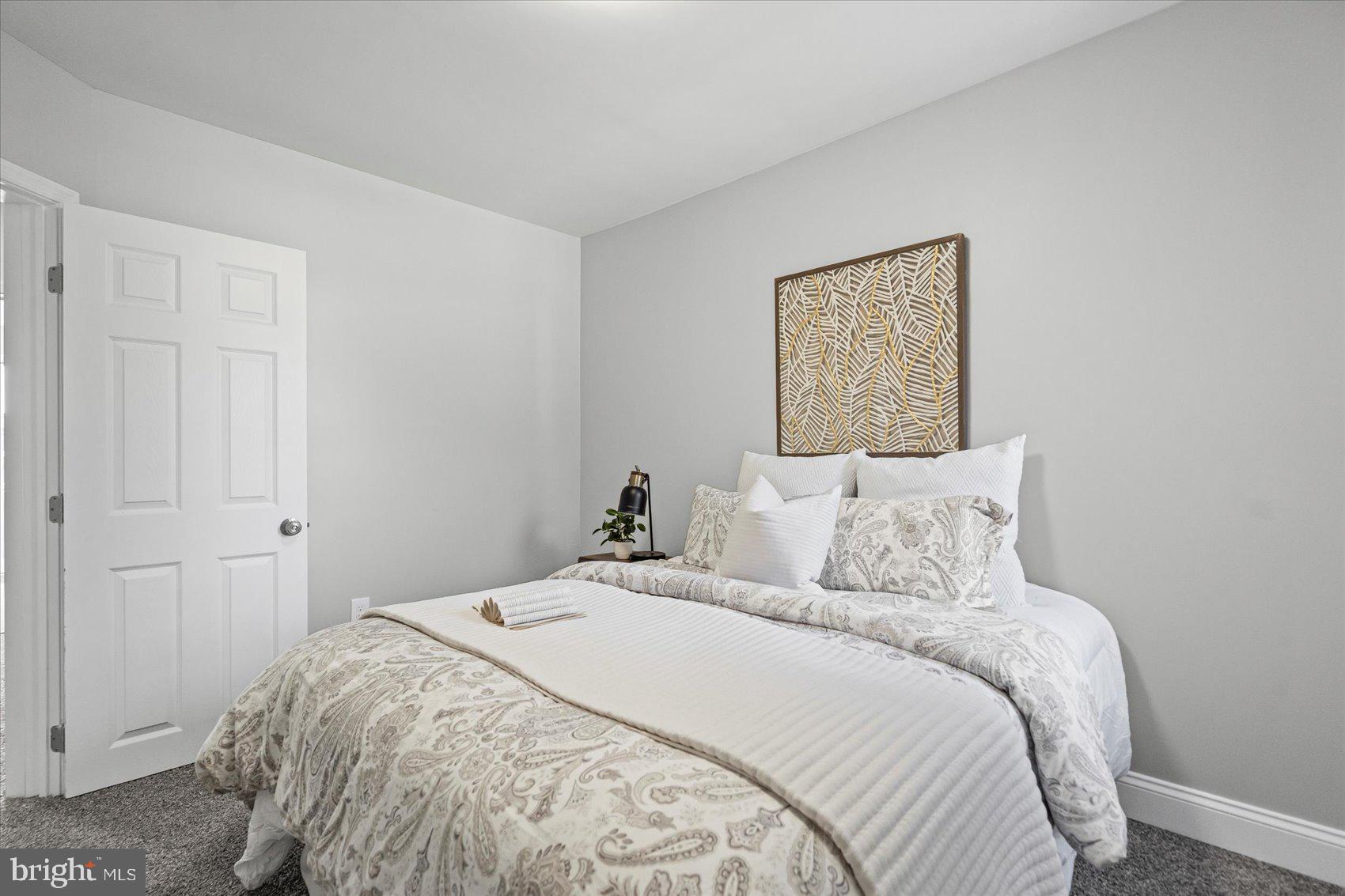 3814 Flowerton Road Baltimore, MD 21229 - Photo 27 of 42 a bedroom with a bed and a painting on the wall