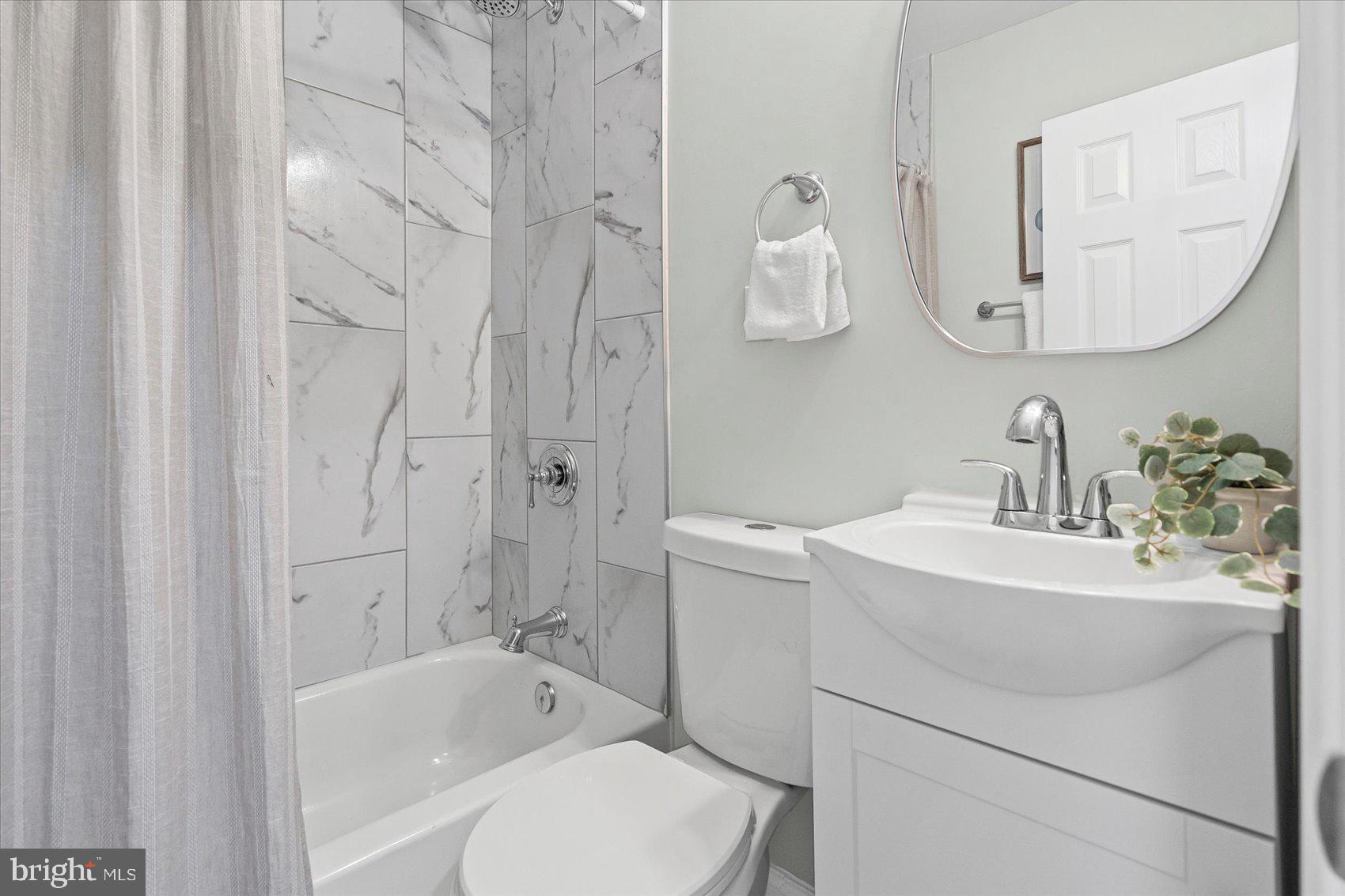 3814 Flowerton Road Baltimore, MD 21229 - Photo 28 of 42 a bathroom with a sink toilet tub and shower