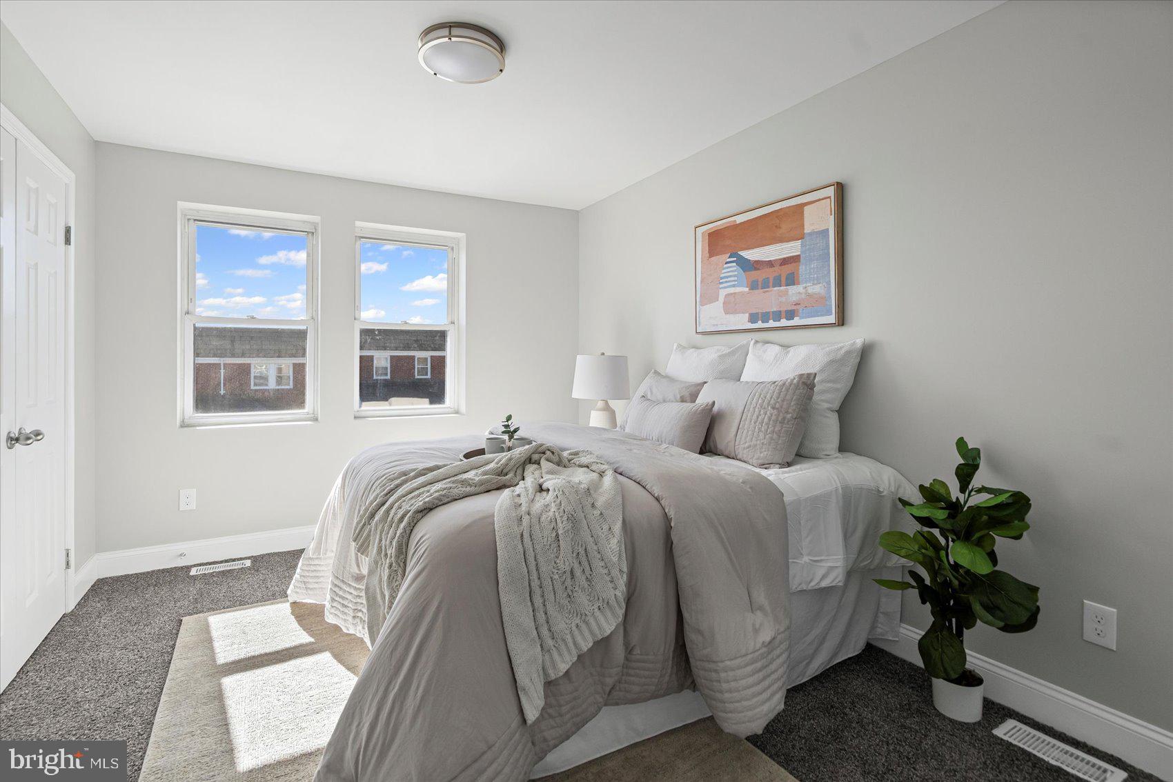 3814 Flowerton Road Baltimore, MD 21229 - Photo 30 of 42 a bedroom with a bed and a potted plant