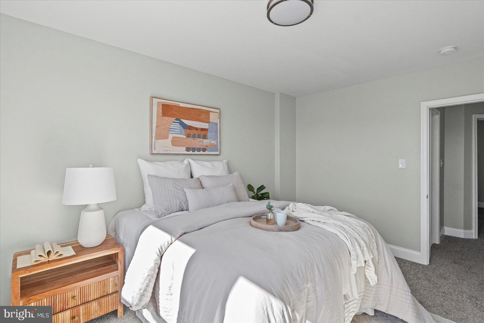 3814 Flowerton Road Baltimore, MD 21229 - Photo 31 of 42 a bedroom with a bed and lamps