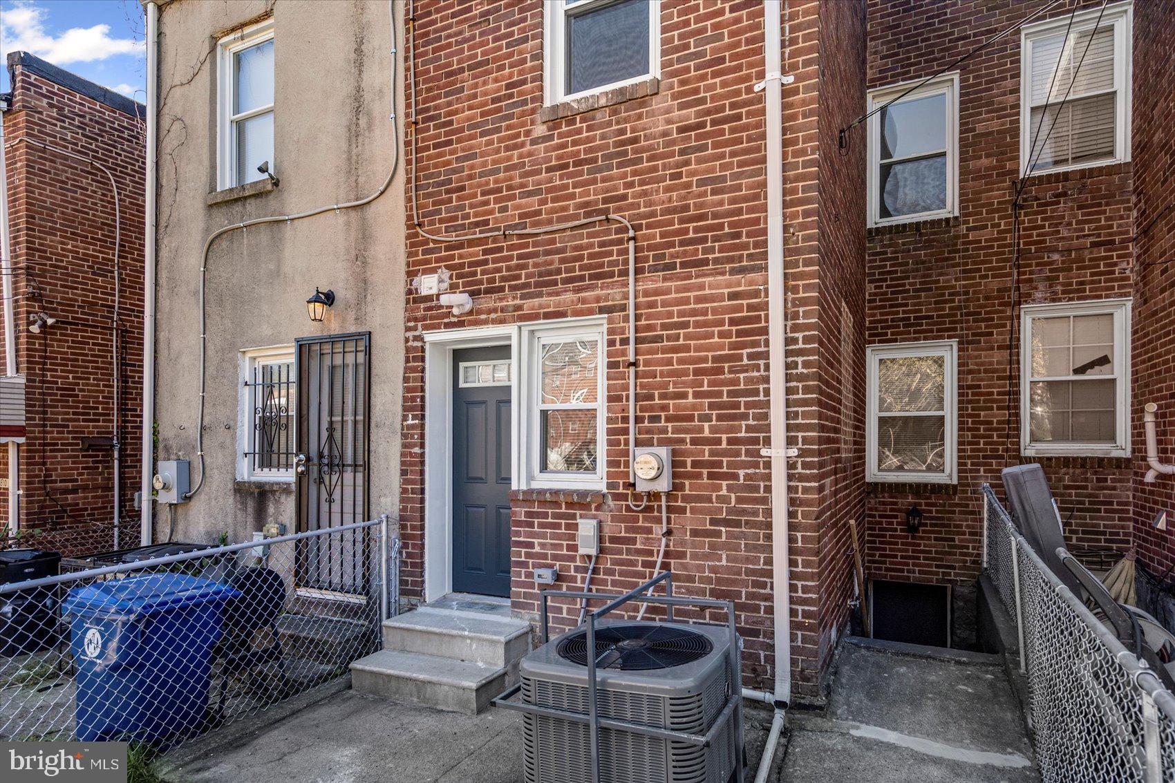 3814 Flowerton Road Baltimore, MD 21229 - Photo 38 of 42 a brick building with a bench and a potted plant