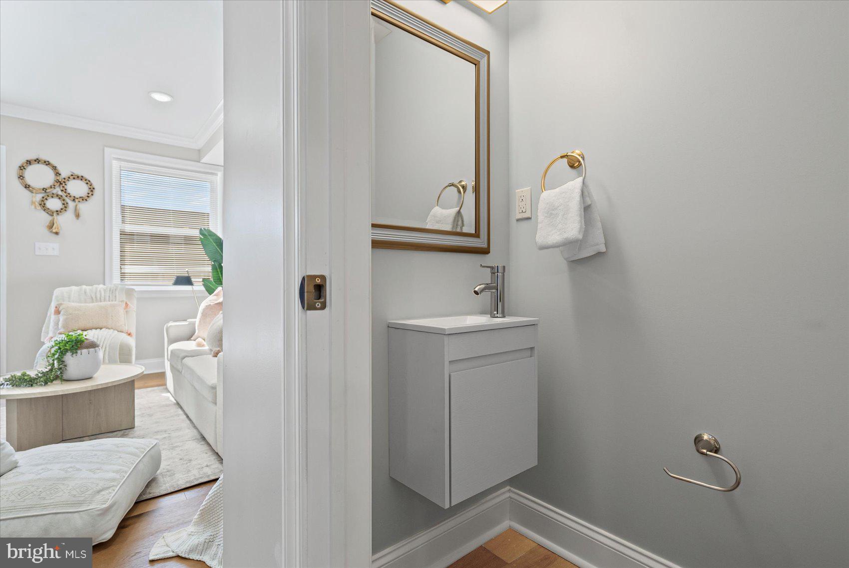 3814 Flowerton Road Baltimore, MD 21229 - Photo 4 of 42 a bathroom with a sink a toilet and mirror