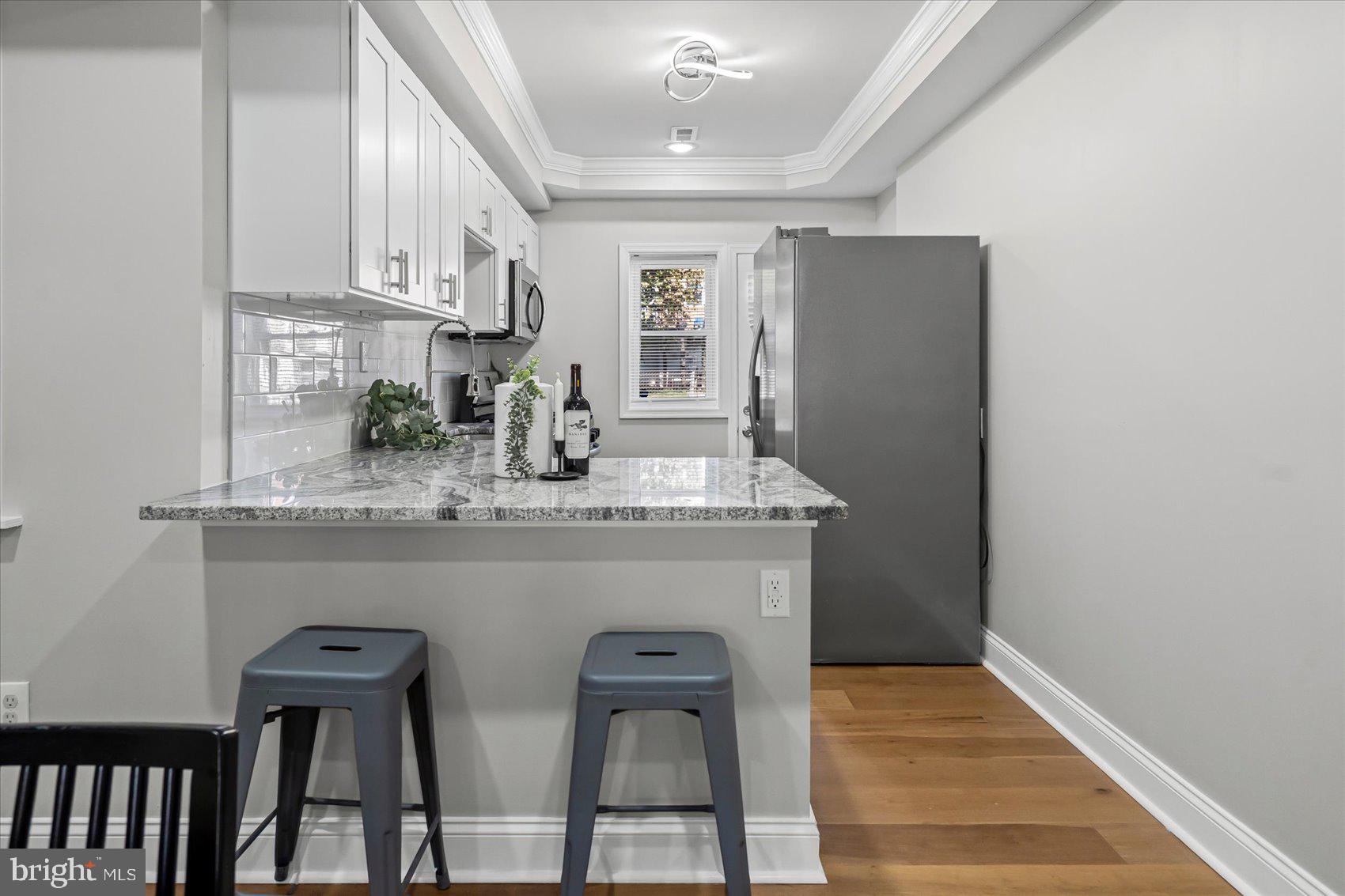 3814 Flowerton Road Baltimore, MD 21229 - Photo 8 of 42 a view of kitchen with cabinets and wooden floor