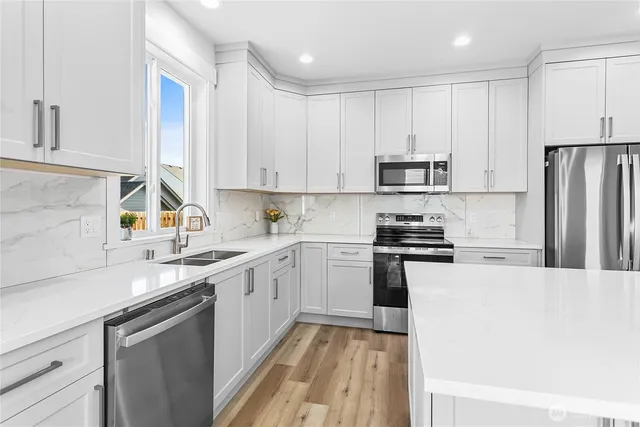 a kitchen with a sink stove and refrigerator