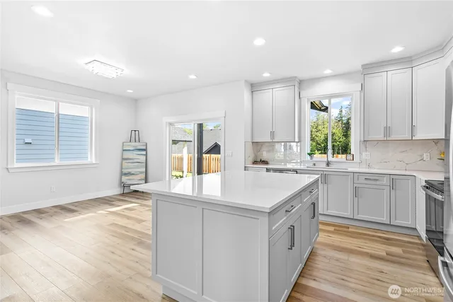 a kitchen with white cabinets and white appliances
