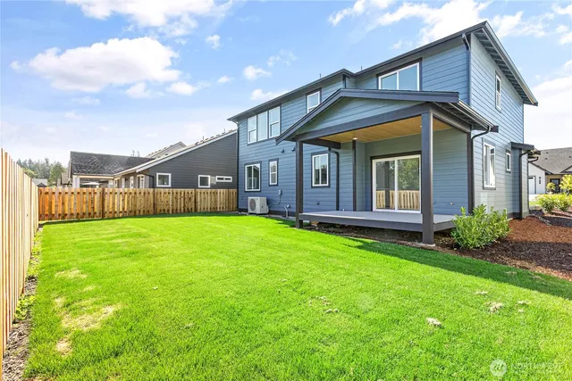 a view of a house with backyard and porch