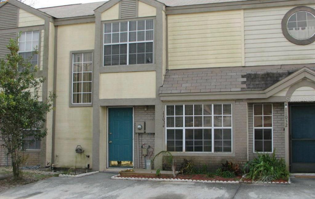 11034 Regency Commons Court Orlando, FL 32837 - Photo 1 of 1 a front view of a house with a yard and garage