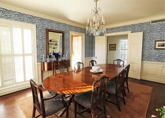 a dining room with furniture a chandelier and wooden floor