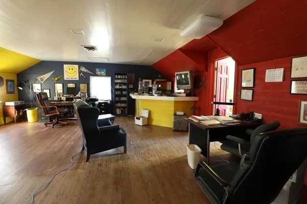 a living room with furniture dining table and a refrigerator