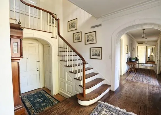a view of entryway with wooden floor and stairs