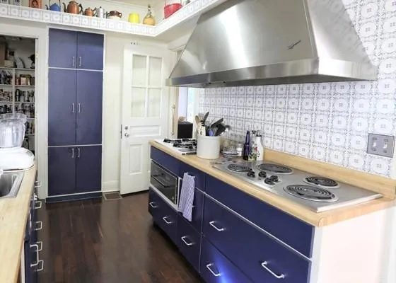 a kitchen with a sink cabinets and wooden floor