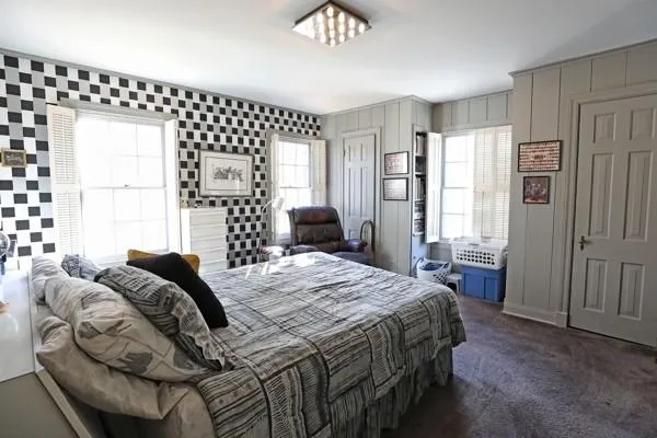 a bedroom with a bed lamps and window