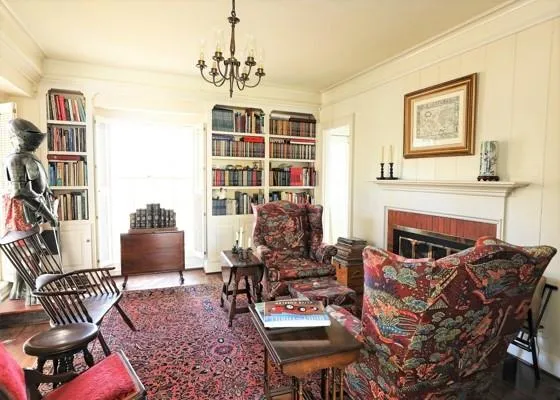 a living room with furniture a fireplace and a book shelf